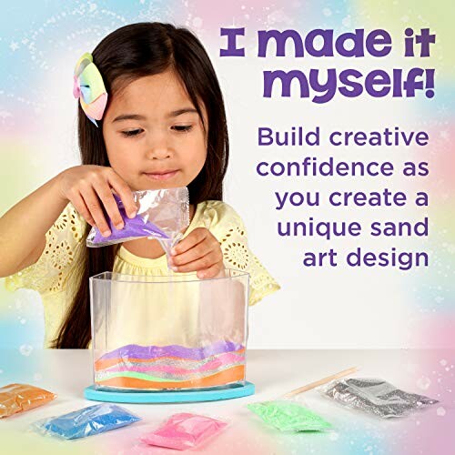 Child making sand art with colorful sand and container.