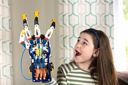 Child amazed by a robotic hand toy.