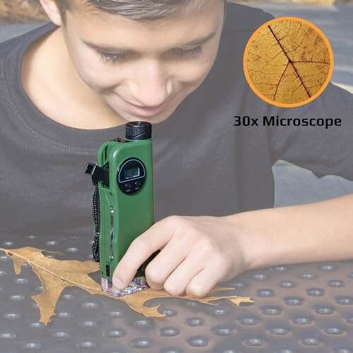 Child examining a leaf with a 30x portable microscope.