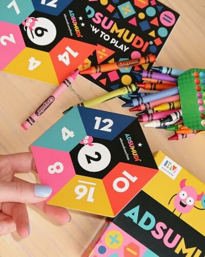 Colorful educational game pieces and crayons on a table