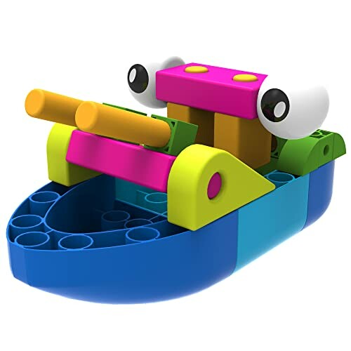 Colorful toy boat with large eyes and two yellow cannons.