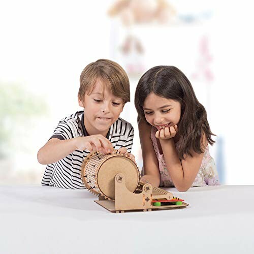 Two children playing with a wooden gear toy on a table.