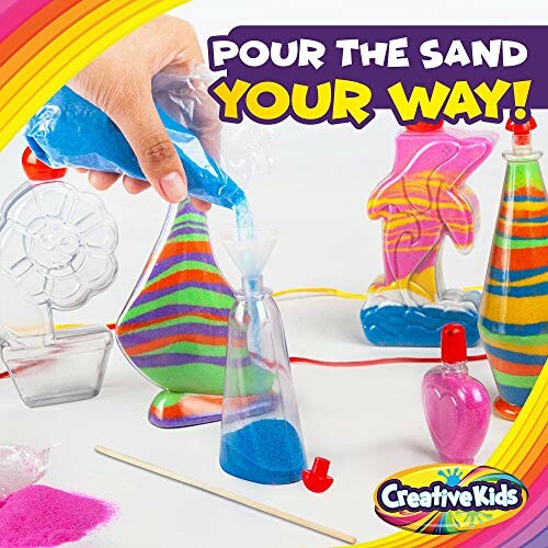 Colorful sand art kit with various shaped containers and sand being poured.