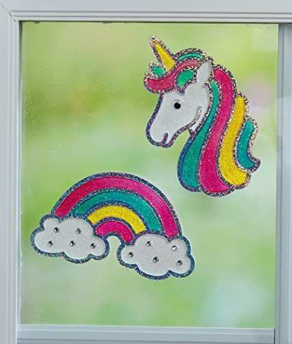 Colorful unicorn and rainbow stickers on a window.